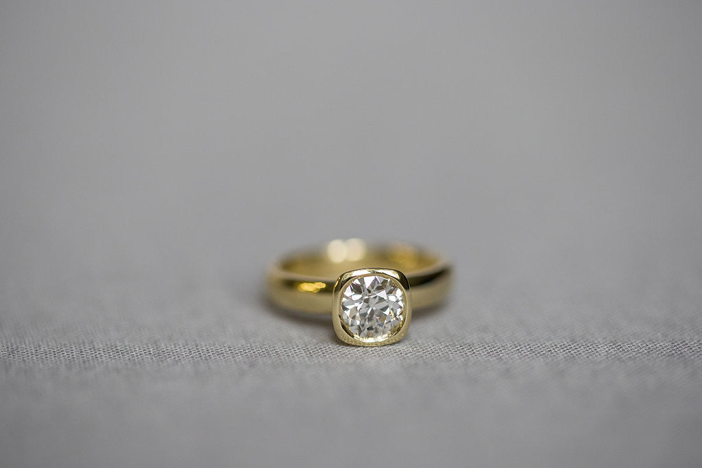 yellow gold cushion bezel ring round diamond