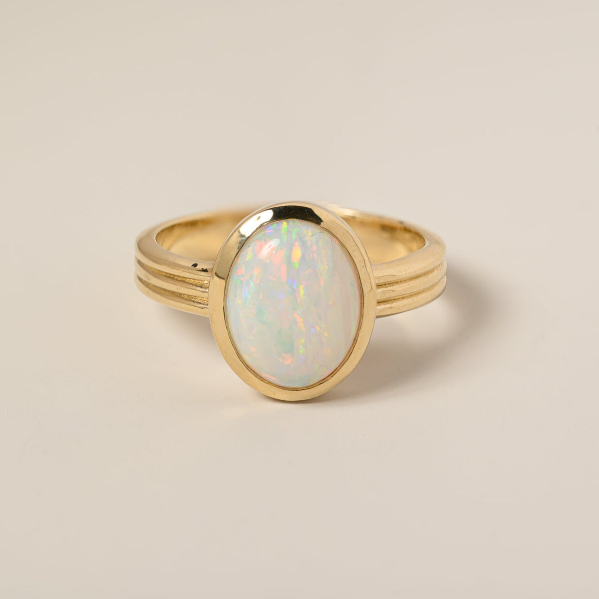 14k yellow gold bezel set oval opal grooved ridge band ring