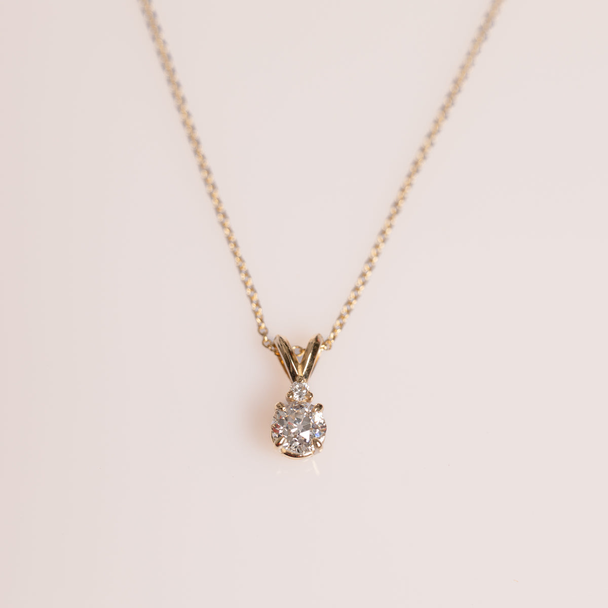 14k yellow gold prong set 0.68ct old european cut diamond with tiny diamond accent split bail illusion diamond pendant necklace