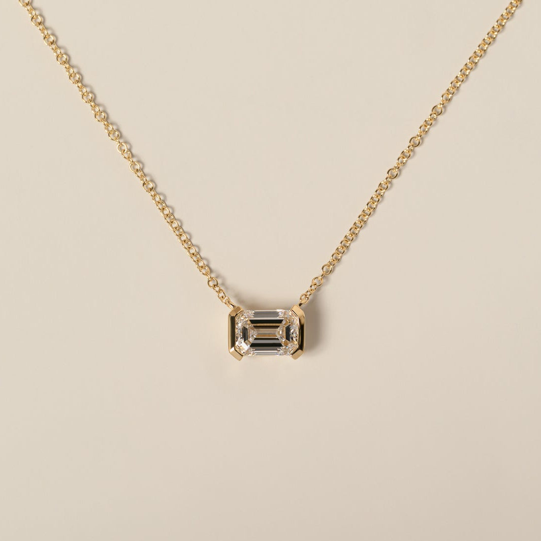 14k yellow gold half bezel set east west emerald cut lab diamond pendant necklace