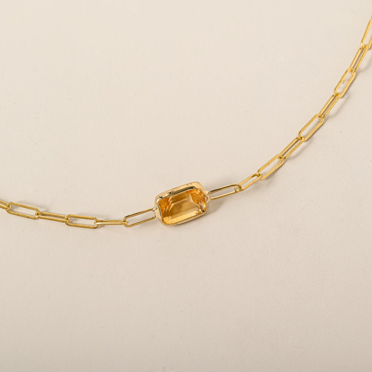 14k yellow gold emerald cut east west bezel set citrine paperclip chain bracelet