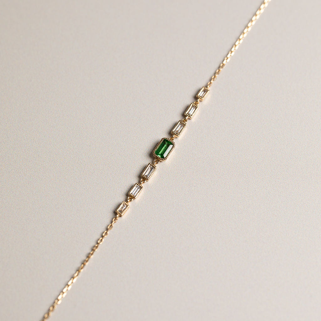 14ky bezel set emerald cut tsavorite with baguette diamonds milgrain detailing bracelet