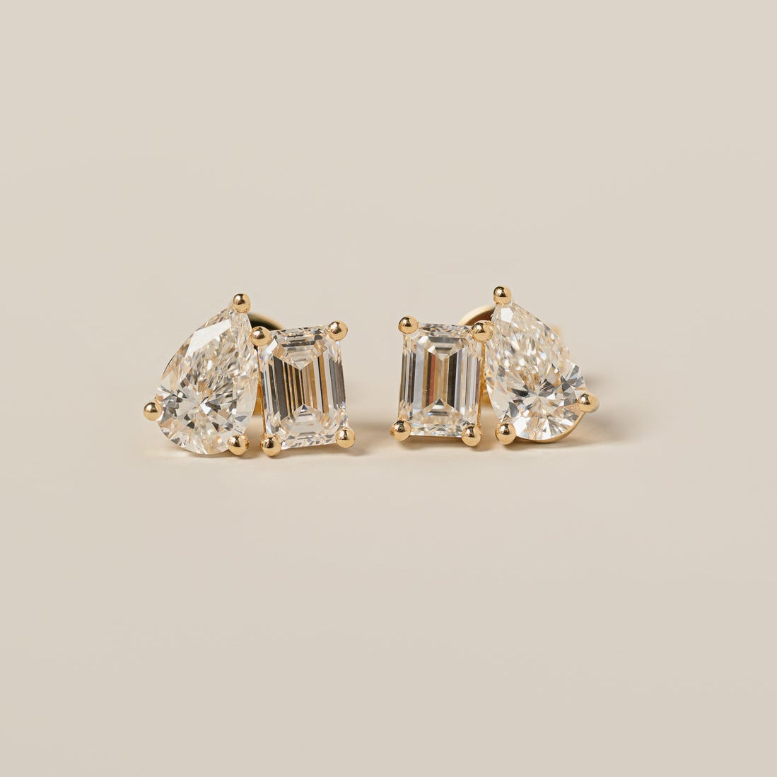 14k yellow gold emerald cut pear shape lab diamond toi et moi stud earrings