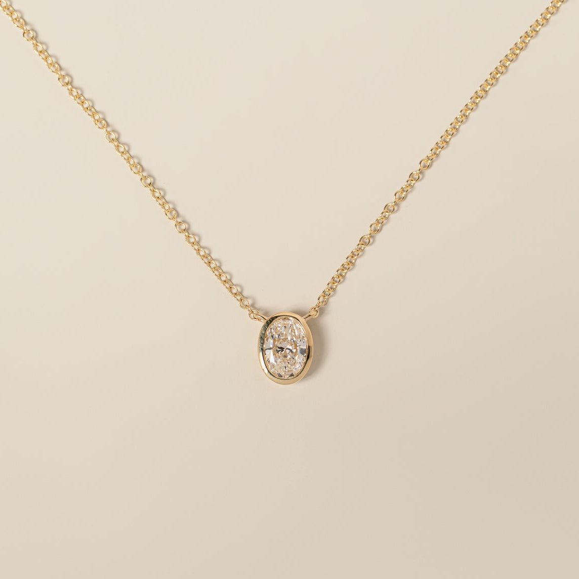 14k yellow gold bezel set oval cut lab diamond pendant necklace
