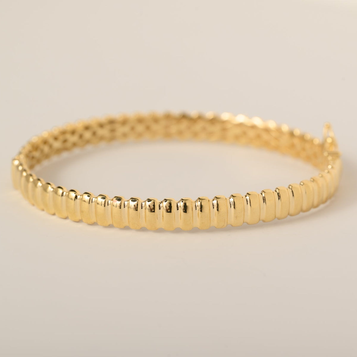 14k yellow gold polished grooved ridged bangle bracelet with safety clasp closure