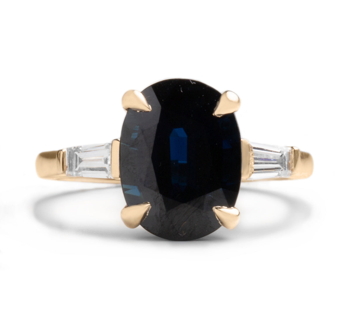 14k yellow gold 4.65ct oval cut dark blue sapphire claw prong ring with tapered baguette diamond side stones ring