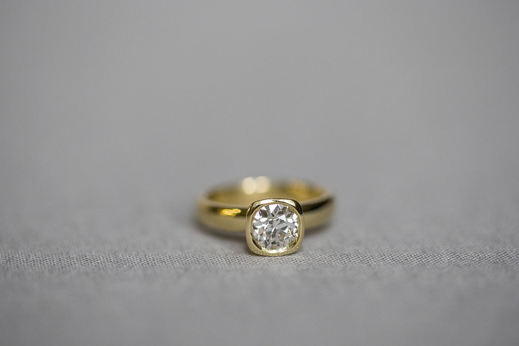yellow gold cushion bezel ring round diamond