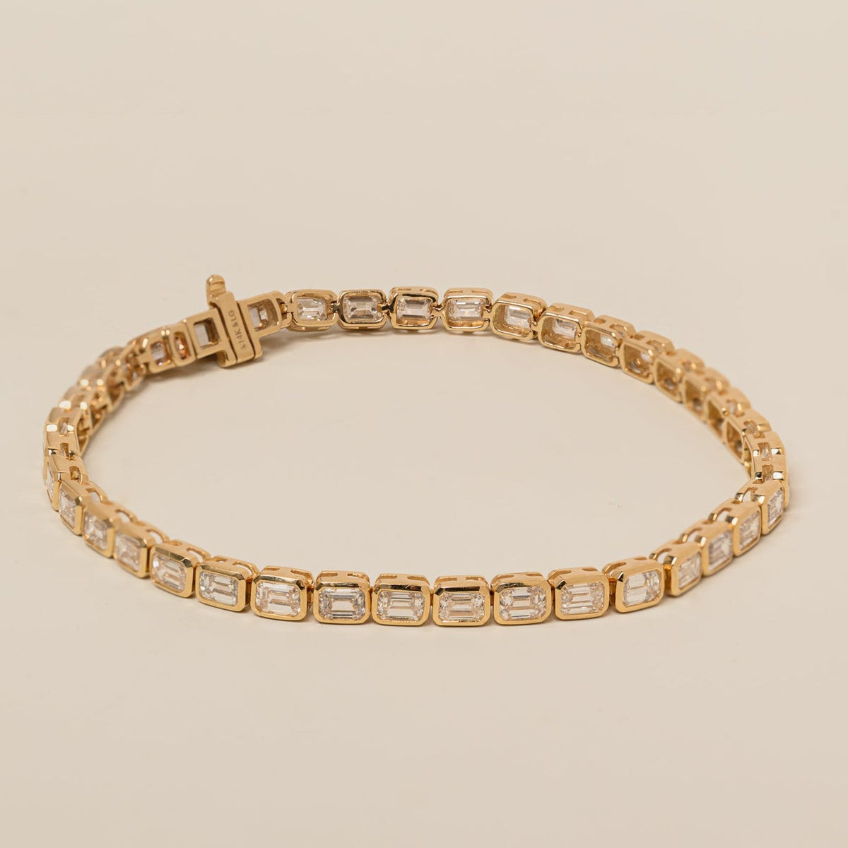14k gold east west lab diamond emerald cut bezel set tennis bracelet 