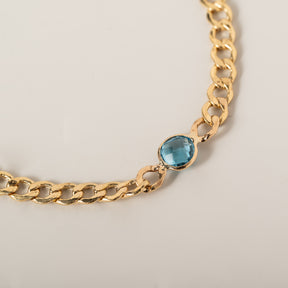14k yellow gold curb chain bezel set round blue topaz bracelet