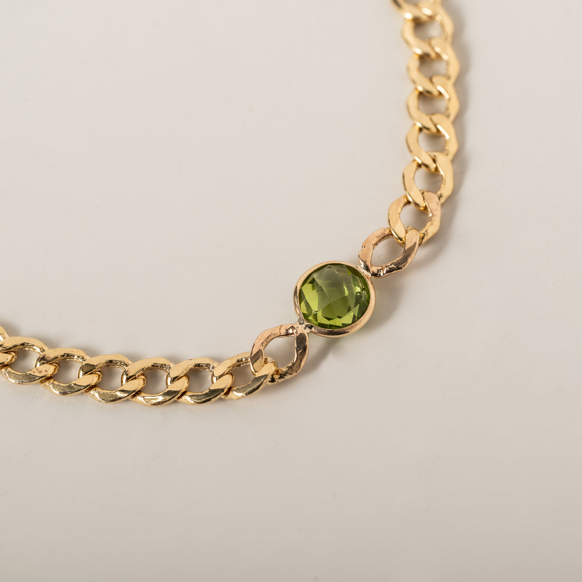 14k yellow gold curb chain bezel set round peridot bracelet