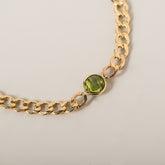 14k yellow gold curb chain bezel set round peridot bracelet