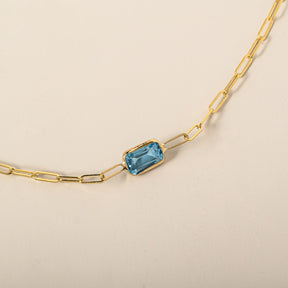14k yellow gold emerald cut east west bezel set blue topaz paperclip chain bracelet