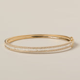 14k gold channel set baguette diamond bangle with diamond pave edging