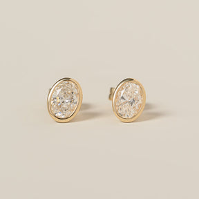 14k yellow gold bezel set oval cut lab diamond stud earrings