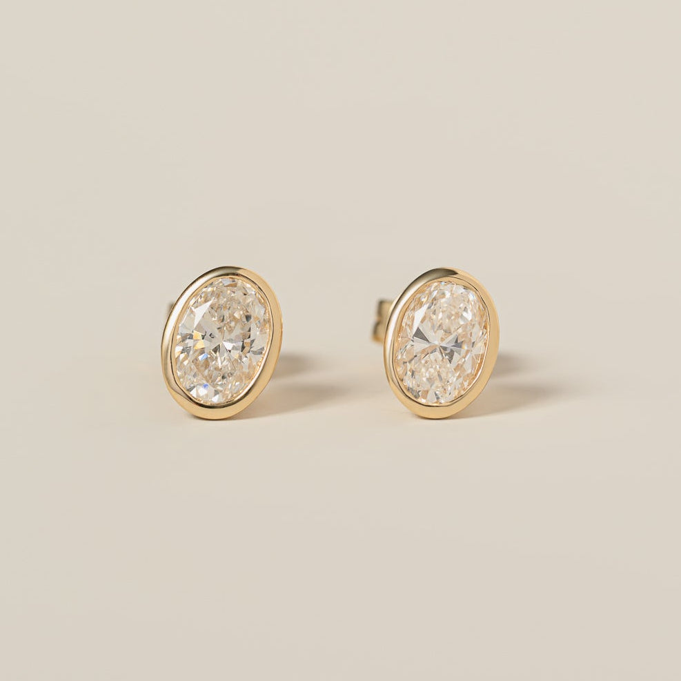 14k yellow gold bezel set oval cut lab diamond stud earrings