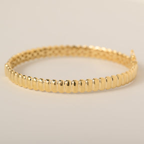 14k yellow gold polished grooved ridged bangle bracelet with safety clasp closure