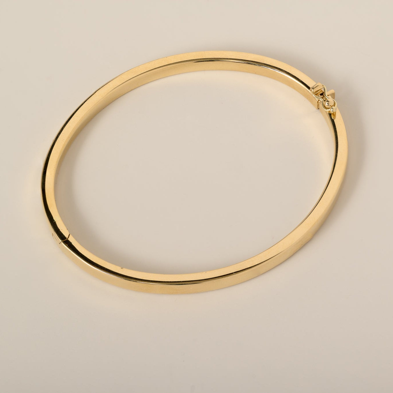 14k gold flat 4mm plain bangle with hinge and safety clasp closure