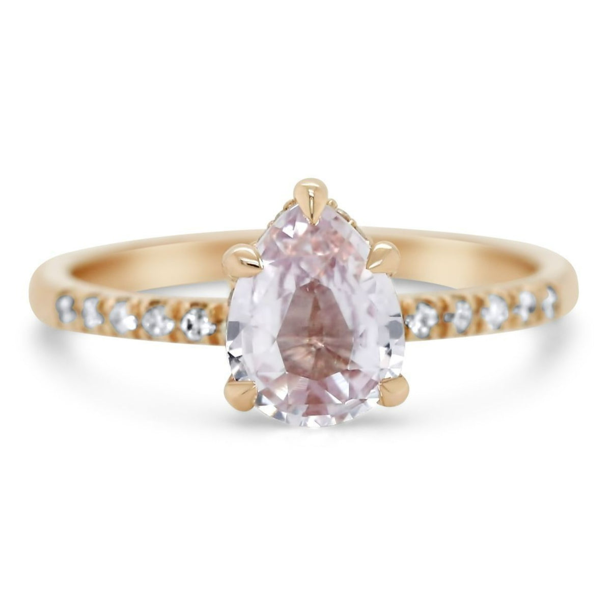 14k rose gold pear shaped peach sapphire engagement ring with diamonds on the band 