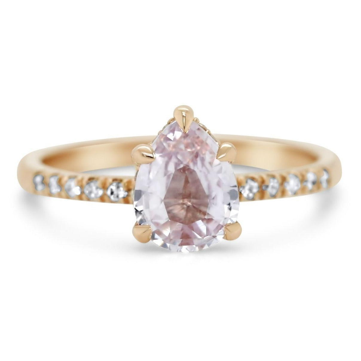 14k rose gold pear shaped peach sapphire engagement ring with diamonds on the band 