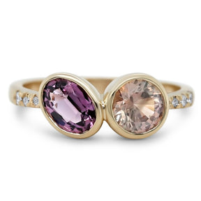 14k yellow gold purple spinel and peach sapphire two stone bezel set ring with diamonds on each side of the band