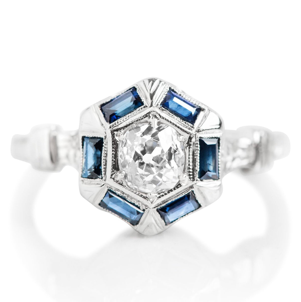 DIAMOND AND BAGUETTE CUT SAPPHIRE ESTATE ENGAGEMENT RING WITH A PLATINUM BAND AND FLOWER DETAILS