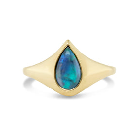 Pear shaped black opal set flush in 14k yellow gold signet style ring
