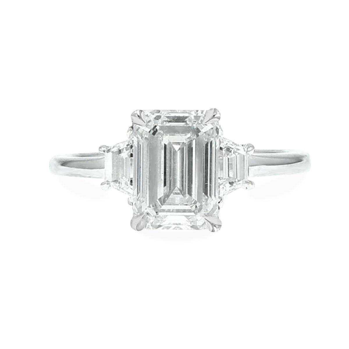 emerald cut lab grown three stone diamond engagement ring with trapezoid side stones 14k white gold