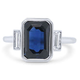14k white gold blue emerald cut sapphire with diamond baguette side stones
