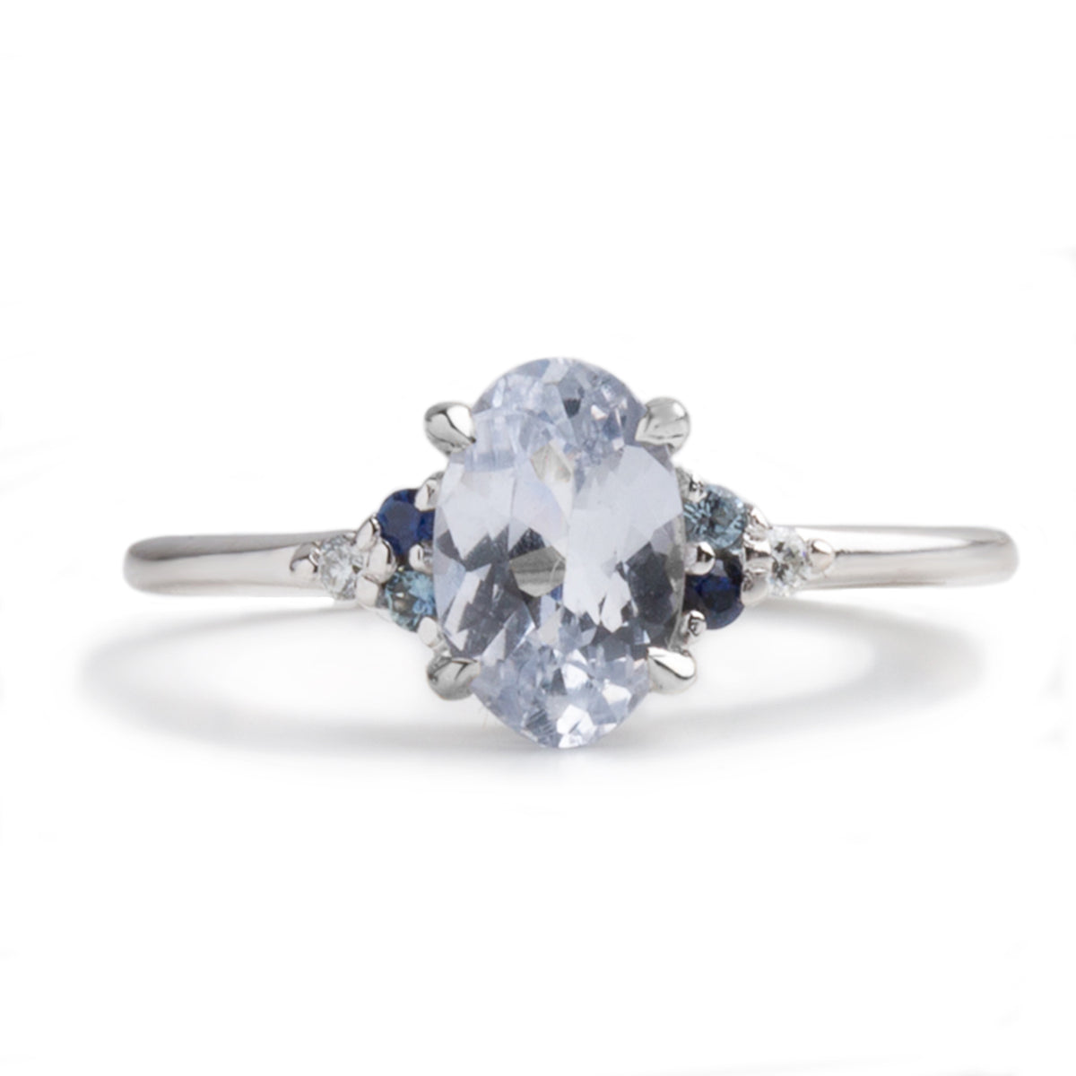 1.35ct oval cut white sapphire with diamond and sapphire side stones 14k white gold engagement ring