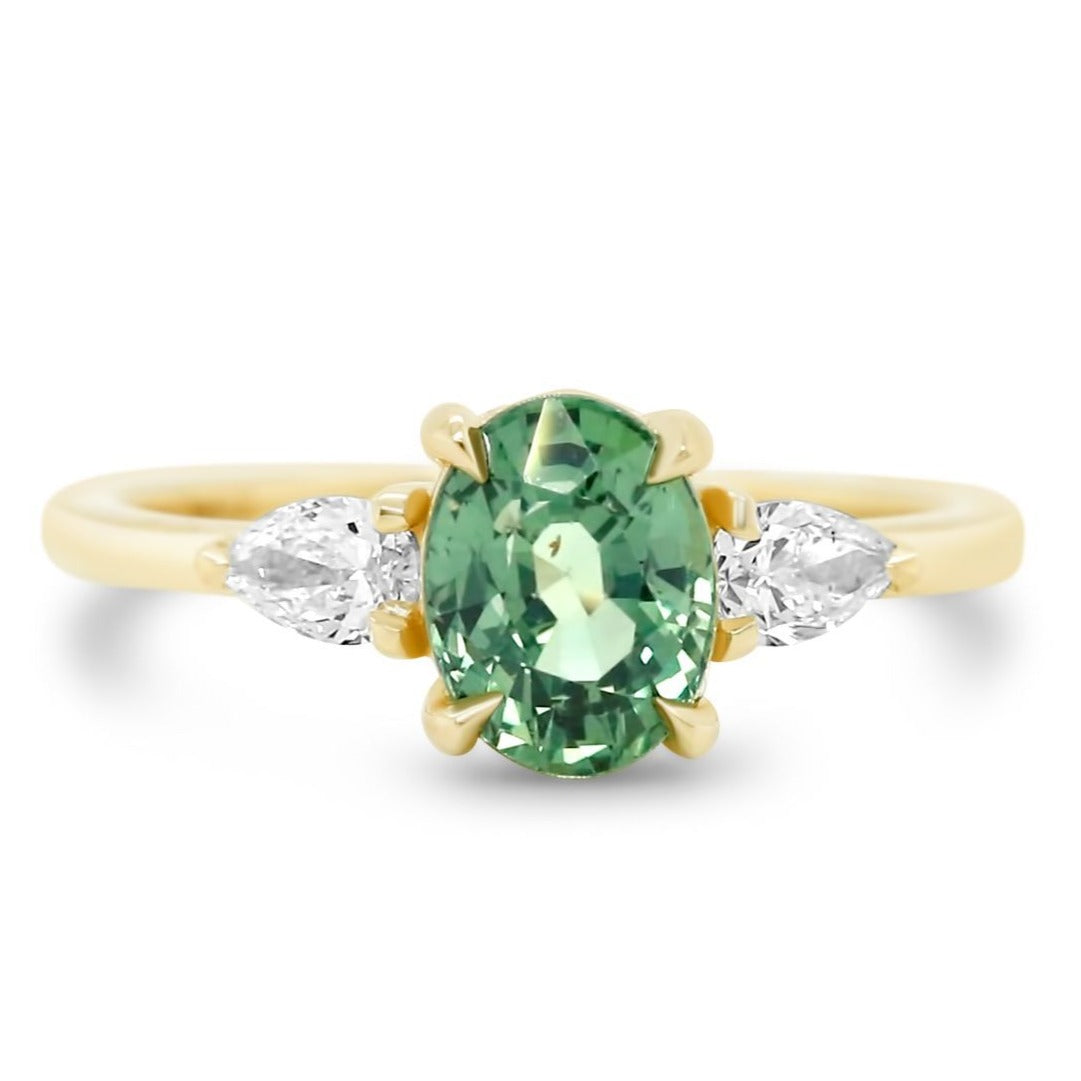 14k yellow gold three stone oval green sapphire ring with pear shaped diamonds on each side