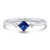 18k white gold three stone antique ring with a nsew blue sapphire and round diamonds